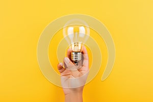 Innovative Hands catching light bulb. Generate ai