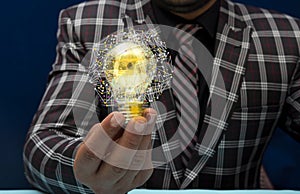 Innovative idea concept shown by businessman holding bulb in hand