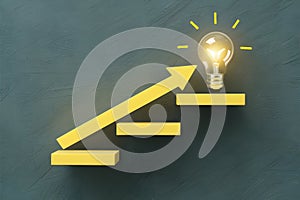 Innovative staircase design with glowing light bulb and yellow arrow on grey background