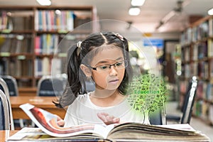 Innovative stem education and tree of knowledge concept with kid reading book in library