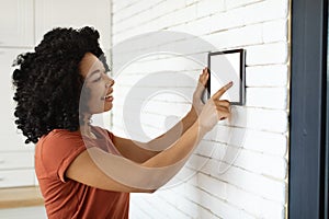 Innovative Technology. Black Woman Using Blank Digital Tablet For Smart Home Settigns