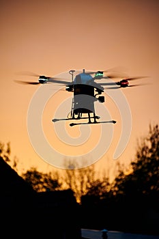 inovation drone with automated external defibrilator aed flying in sunset