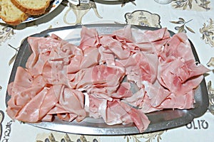 Platter with mortadella and `cotto` ham on a table photo