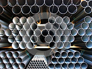 Inox Steel pipes stacked on pile.