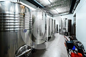Inox wine barrels stacked in modern winery cellar in Spain