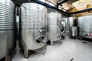 Inox wine barrels stacked in modern winery cellar in Spain photo
