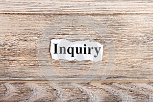 Inquiry text on paper. Word Inquiry on torn paper. Concept Image