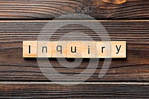 Inquiry word written on wood block. inquiry text on table, concept