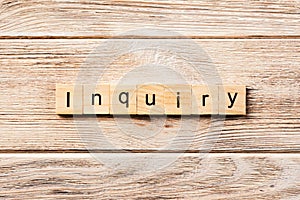 Inquiry word written on wood block. inquiry text on table, concept