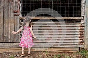 Inquisitive girl exploring old shed photo