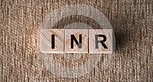 INR - International Normalized Ratio acronym on cubes on wooden surface. Medical concept