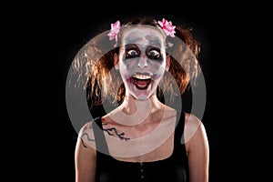 Insane female clown in front of black