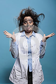 Insane and silly looking crazy scientist with messy hairstyle and dirty face