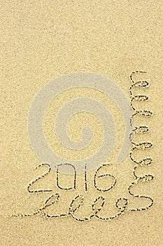 Inscription 2016 and streamers in the sand on the beach