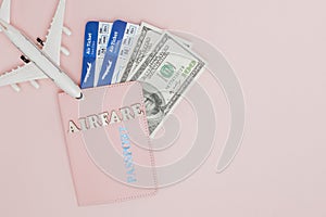 Inscription airfare , Airplane, air ticket and money on a pink background. Travel concept, copy space