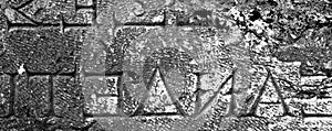 Inscription on the Ancient Greek Carved on Stone in Ancient Necropolis in Pamukkale, Modern Turkey. Monochrome Photo