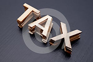 The inscription is arranged from letters cut out of wood on the table. The word â€“ tax