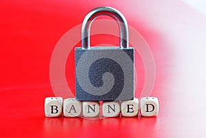Inscription banned with closed padlock on it. Red and white background. Concept of banned internet forum, chat room, website,