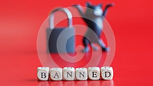 Inscription banned, closed padlock and silhouette of a toy cat on a red background. Concept of banned internet forum, website,