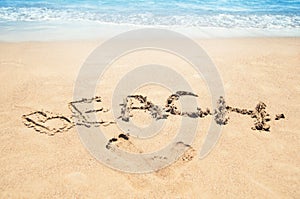 Inscription beach on the sand. Beach season. Rest on the sea