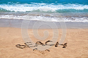 Inscription beach on the sand. Beach season. Rest on the sea