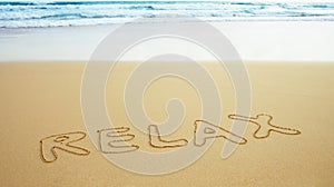 Inscription on beach sand - relax