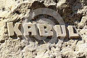 An inscription carved into an Afghan mountain or rock: KABUL. The capital and largest city of Afghanistan