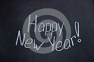 The inscription on the chalkboard Happy New Year in the form of a smile