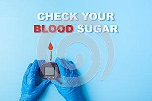 Inscription check your blood sugar and Nurse making a blood test with red blood drop and Glucose meter