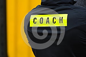 The inscription on the coach sports jacket