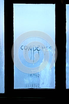 Inscription condense on glass with drops of condensed vapor with drops of water. Close up detail of moisture condensation problems