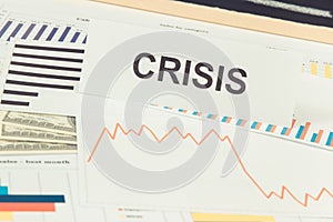 Inscription crisis, currencies dollar and downward graphs representing financial crisis caused by coronavirus. Covid-19