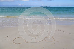 The inscription Cuba on the beach sand. .