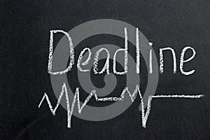 The inscription on a dark blackboard deadline with a curve line