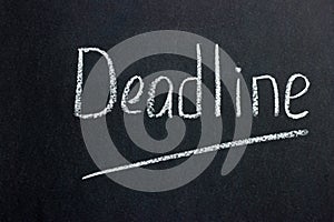 Inscription on a dark blackboard deadline with an underlined line