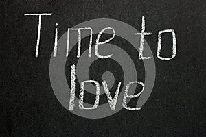 The inscription on the dark board `Time to love`