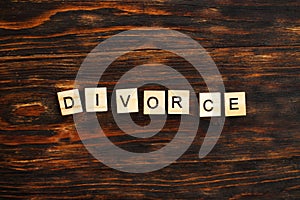 Inscription divorce made by wooden blocks on wooden background. broken family concept