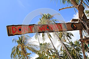 An inscription â€œDonâ€™t worryâ€ on the wooden abandoned hut.