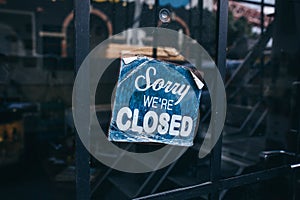 Inscription on a door: Sorry we are closed. Conceptual photo or table on door with information of work. Announcement or