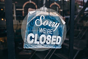 Inscription on a door: Sorry we are closed. Conceptual photo or table on door with information of work. Announcement or