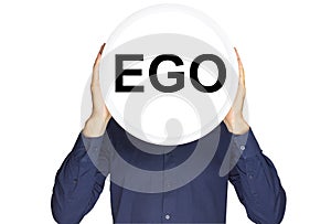 The inscription ego in black letters on a white circle in the hands of a man on a white background.