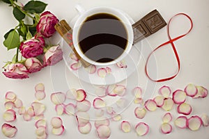 Inscription on the eighth of March from rose petals, coffee, cinnamon, chocolate on a white background chocolate