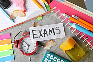 Inscription Exams and different stationary on background, top view