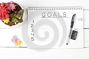 Inscription Goals in a notebook, close-up, top view, concept of planning, setting purpose