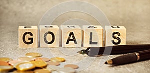 Inscription GOALS on wooden cubes on a gray background