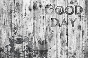 The inscription `Good day` on a gray texture of wood. Have a good day. A cup of coffee.