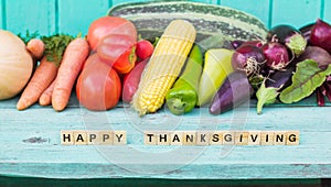 The inscription Happy Thanksgiving on a wooden painted blue background Assortment of Vegetables