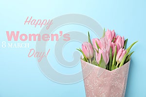 Inscription Happy Women`s Day on background with tulips, space for text