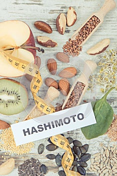 Inscription hashimoto, tape measure and best ingredients for healthy thyroid. Food containing natural vitamins