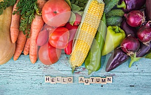 The inscription Hello autumn on a wooden painted blue background Assortment Vegetables